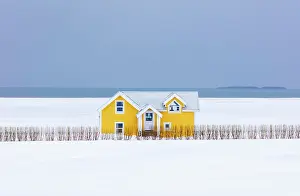 Isolated Prints: Yellow house in snowy winter landscape, South Iceland