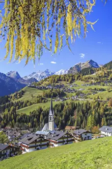Yellow larches color the villages of Selva of Cadore and Saint Lucia hill in autumn