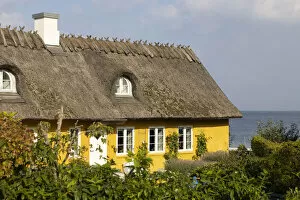 A yellow thatched cottage on the coast near Skodsborg, Zealand, Denmark