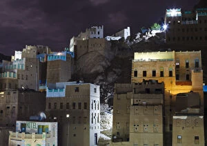 Yemen, Hadhramaut, Wadi Do an, Khuraibah. Buildings lit at night