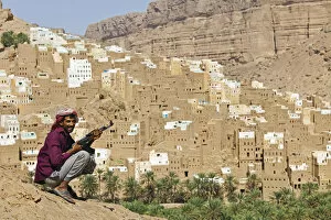 Images Dated 7th March 2012: Yemen, Hadhramaut, Wadi Do an, Ribat Ba-Ashan. A happy Yemeni man holds his AK-47