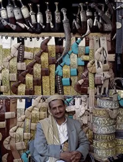Yemen Collection: Yemeni trader sells traditional daggers at his stall