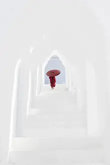 Burmese Prints: A young Buddhist monk holding a red umbrella walks up the steps in Hsinbyume Pagoda