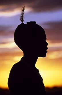 Tribal Jewellery Collection: A young Dassanech boy silhouetted against the evening