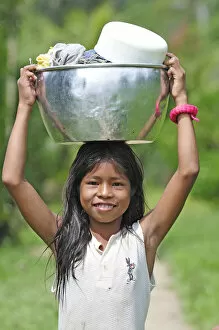Images Dated 27th June 2012: Young girl with a bucket on her head, Amacayon Indian Village, Amazon river, Puerto