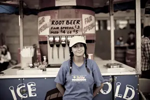 Fairground Prints: A young girl selling root beer at a midway concession at the Calgary Stampede, Canada