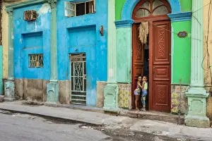 Girls Prints: Two young girls peaking through the door of their house in Centro Habana Province, Havana