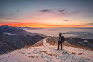 Bollettone Prints: Young hiker admiring Brianza view from Bollettone Mount at sunrise, Como province