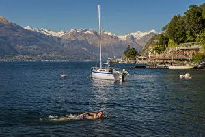 Images Dated 18th May 2015: Young kid swimming into Lake Como, Varenna, Lombardy, Italy