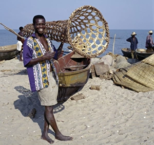 Traditional Methods Prints: A young man carries a wicker fish trap