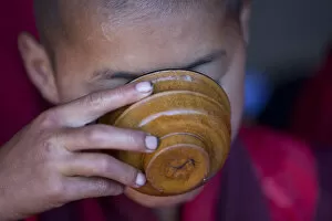 Images Dated 2nd February 2010: A young monk drinking milk from a wooden bowl in Bhutan