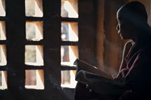 Images Dated 9th May 2020: A young monk looking out of a window while studying inside a temple, UNESCO, Bagan