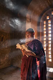 Side View Prints: A young monk reading by a window inside a temple, UNESCO, Bagan, Mandalay Region, Myanmar