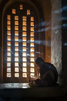 Images Dated 9th May 2020: A young monk studying by a window inside a temple, UNESCO, Bagan, Mandalay Region