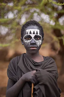 Ethnic Gallery: A young Msai warrior holding a stick in the Ngorongoro Protected Area, Tanzania