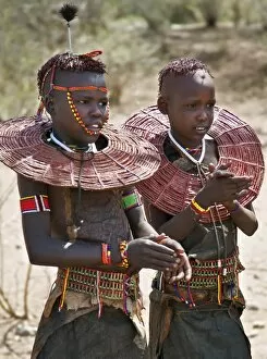 Wide Necklaces Collection: Two young Pokot girls wearing traditional ornaments that denote their unmarried status