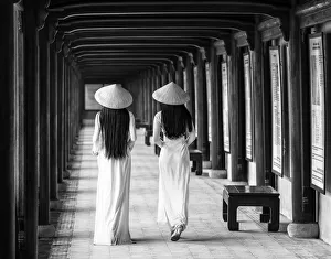 Two young women wearing traditional national costume, ao dai, in the Imperial City