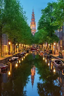 Church Tower Prints: Zuiderkerk Tower near trees and buildings at Groenburgwal canal at twilight